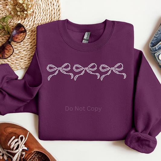 Coquette Bow Rhinestone Transfer on a purple tshirt front side